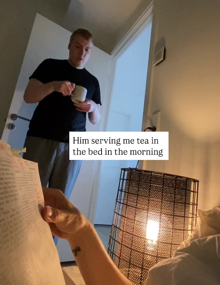 The image captures a sweet and thoughtful moment: an autism son serving tea in bed in the morning.
